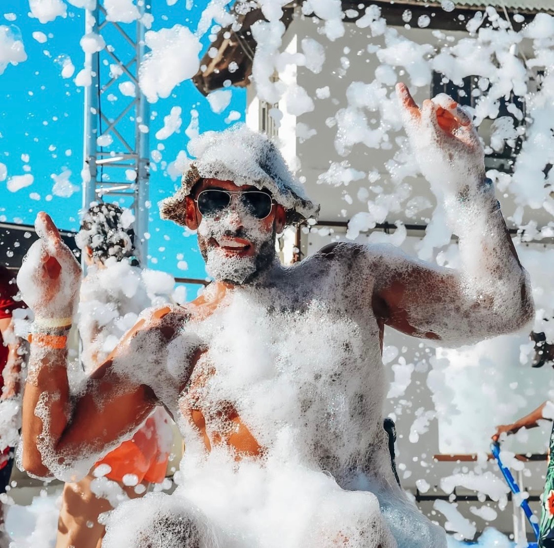 Guest covered head to toe in foam dancing at a college foam party