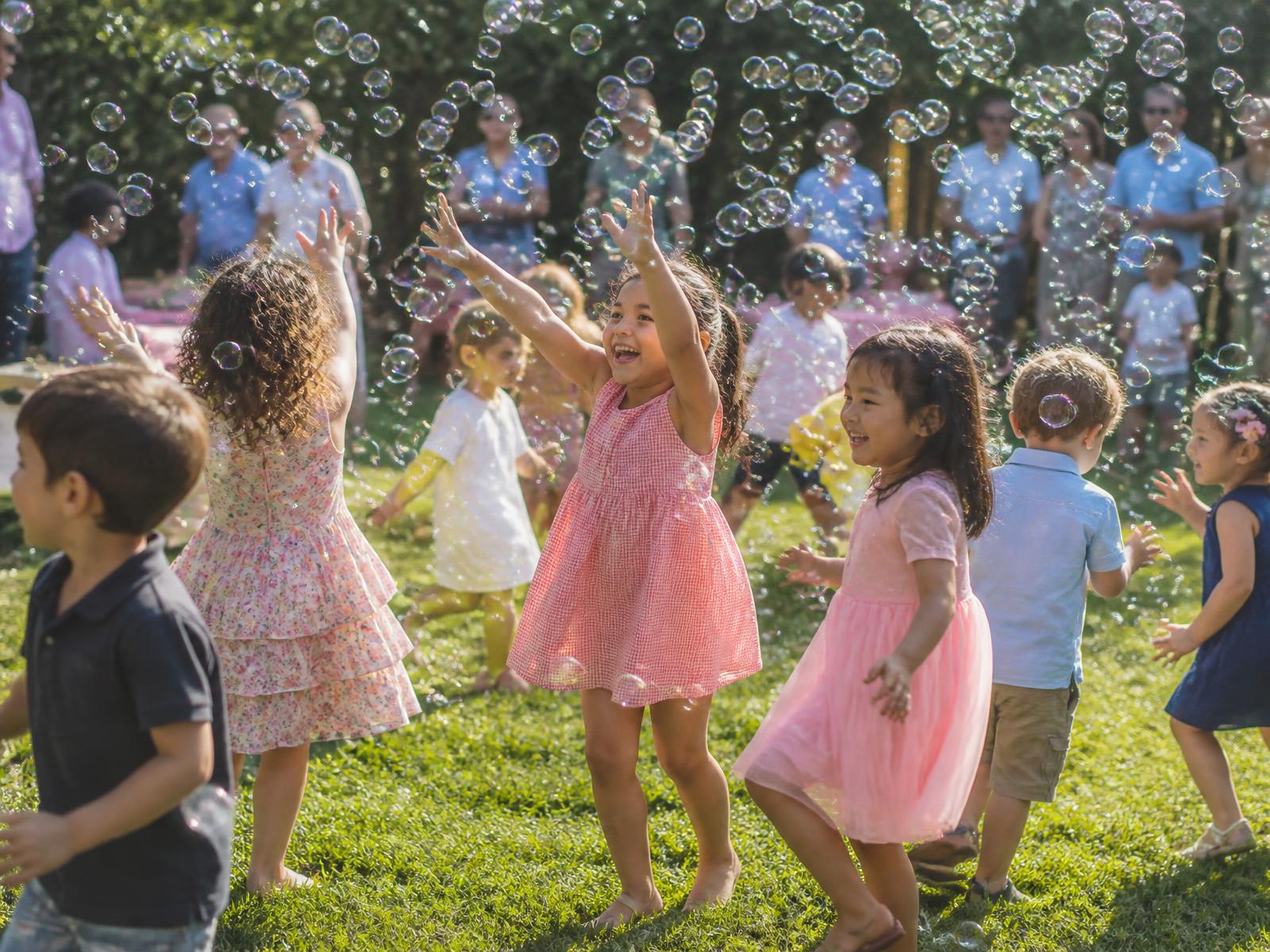 Bubble party in Cincinnati with young children playing in bubbles